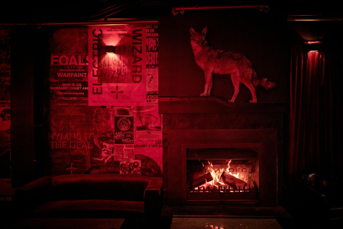 Altar's taxidermy coyote mascot stands above the open fire in the lounge bar