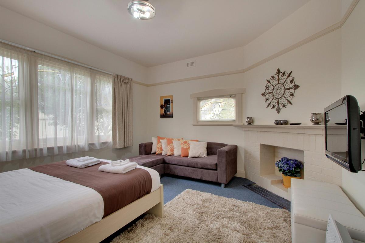 Spacious Master bedroom with chaise and TV
