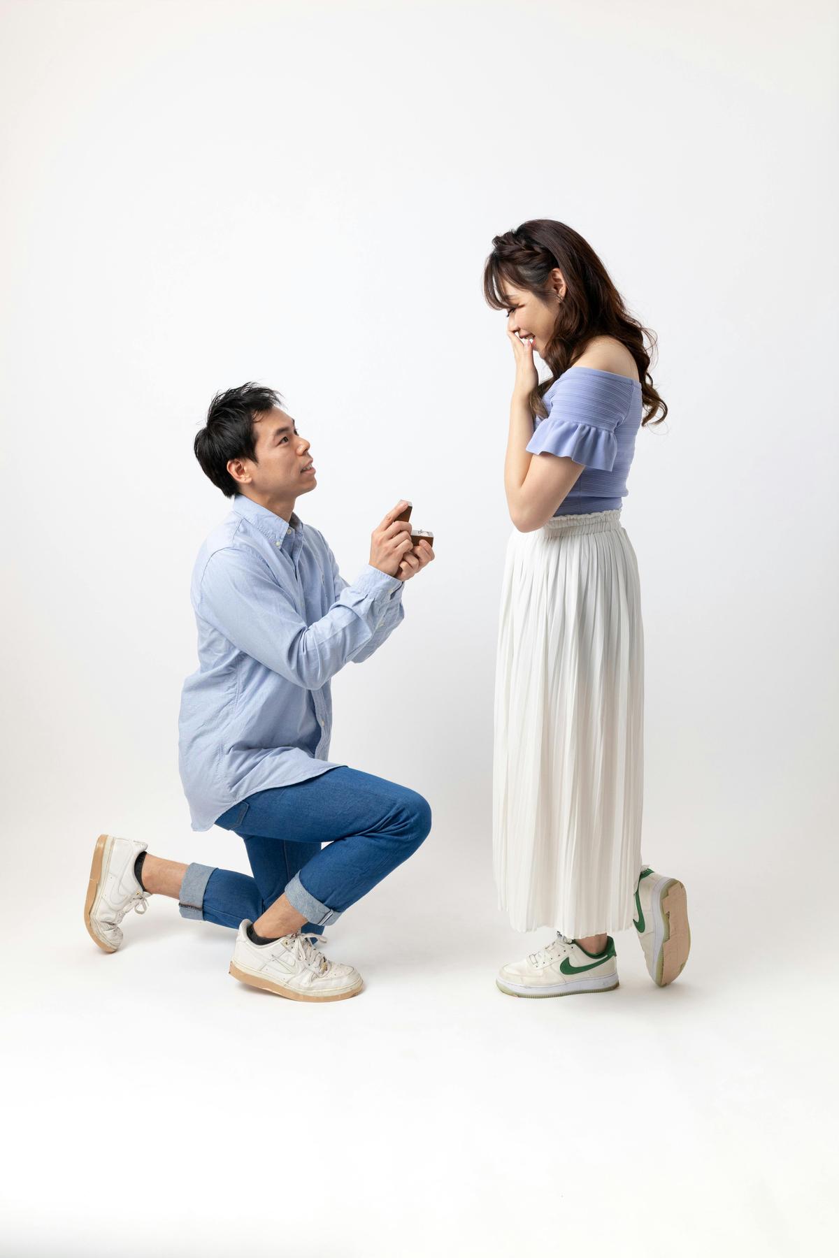 Couple capturing engagement photos in a mirror-based studio