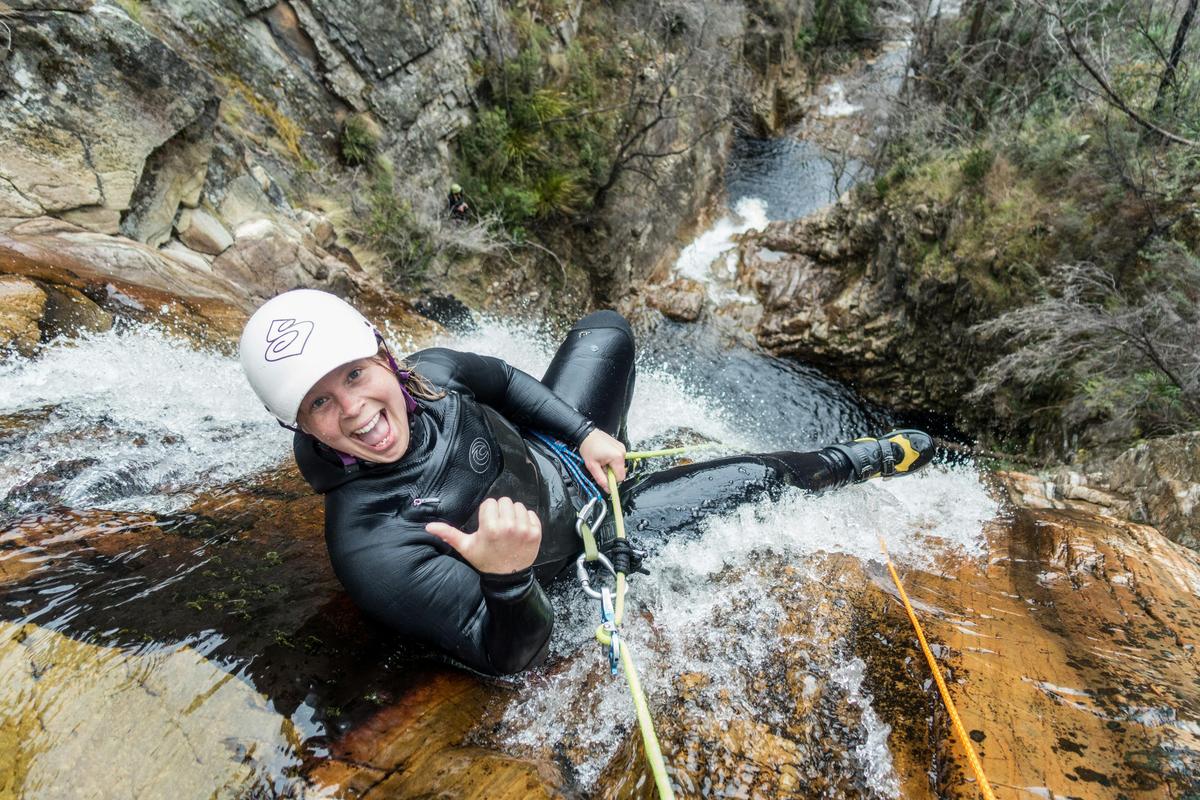 Ready to drop off a big waterfall on a canyoning tour