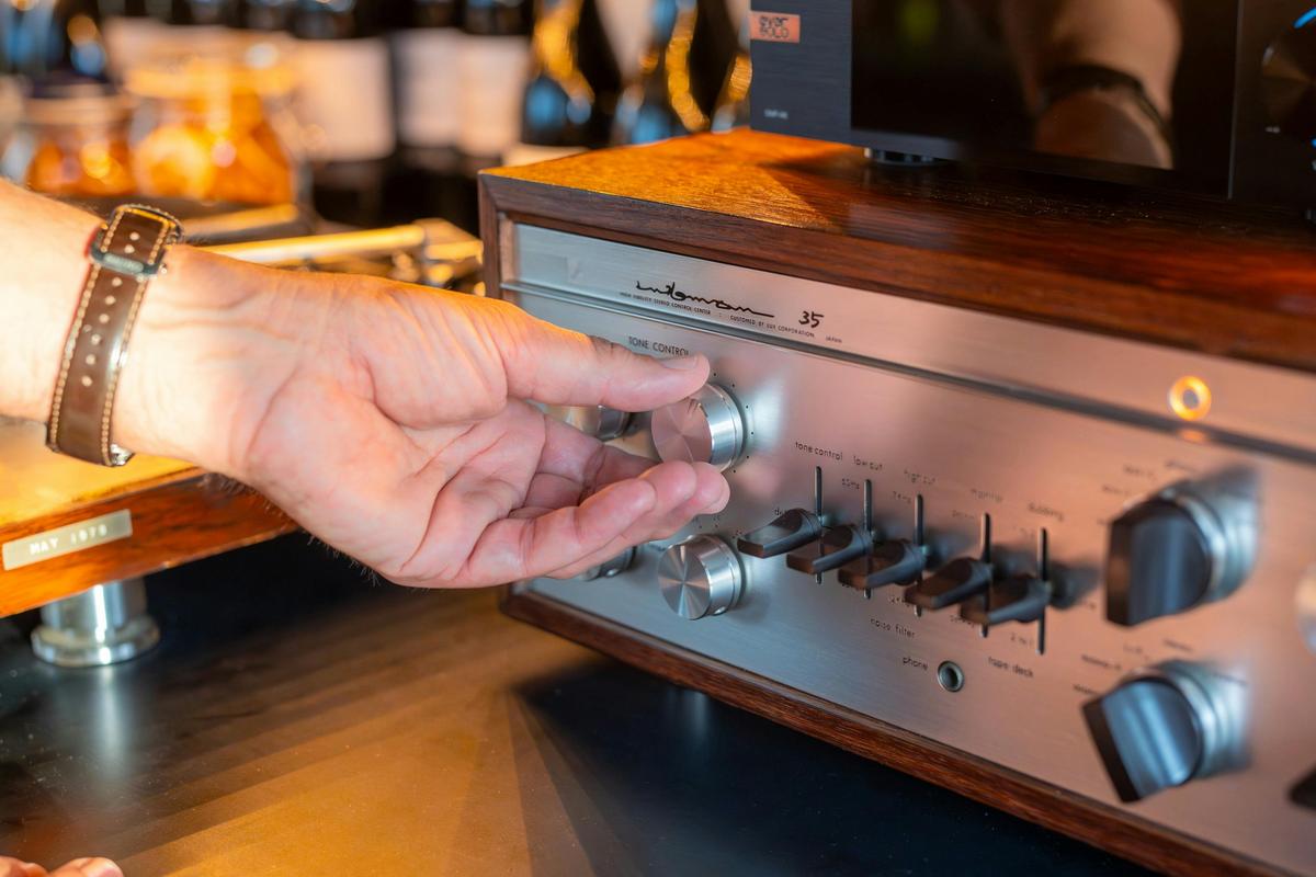 Dill Pickle Club bartender adjusting a Luxman amp