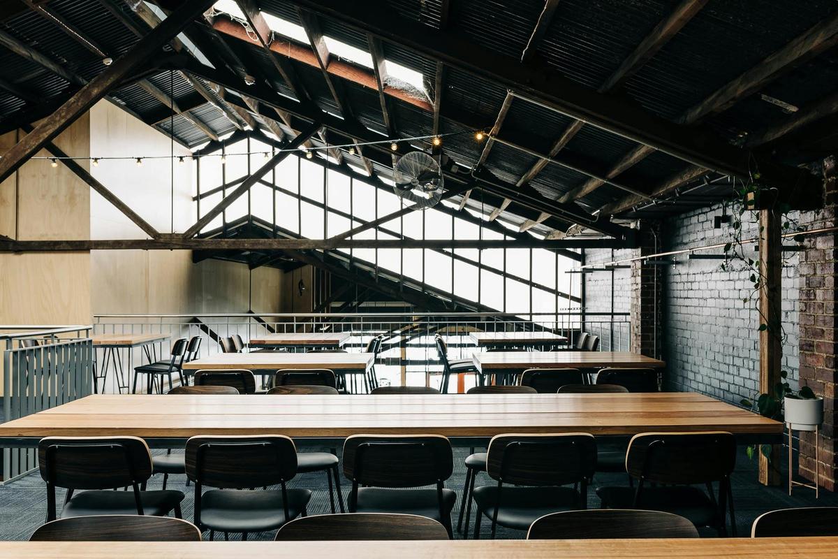 A mezzanine featuring long sharing tables and festoon lighting