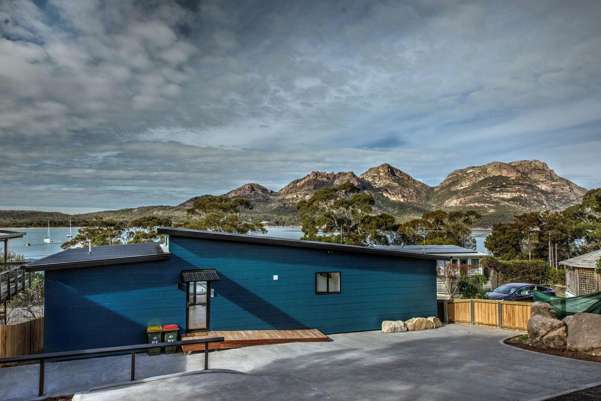 A stunning view of the ocean and mountains from this property