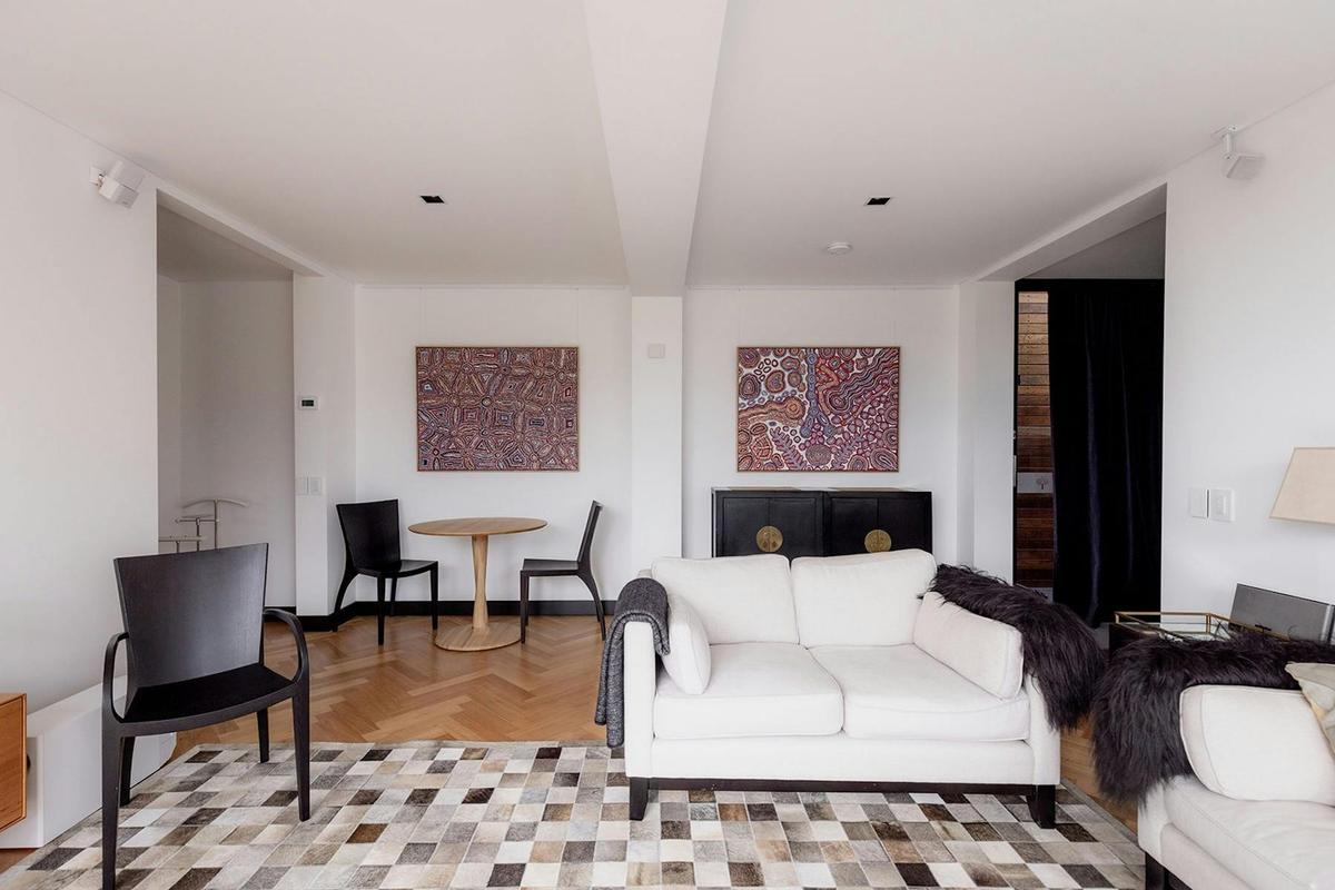 Stylish suite lounge with contemporary furnishings and natural light, ideal for social gatherings.