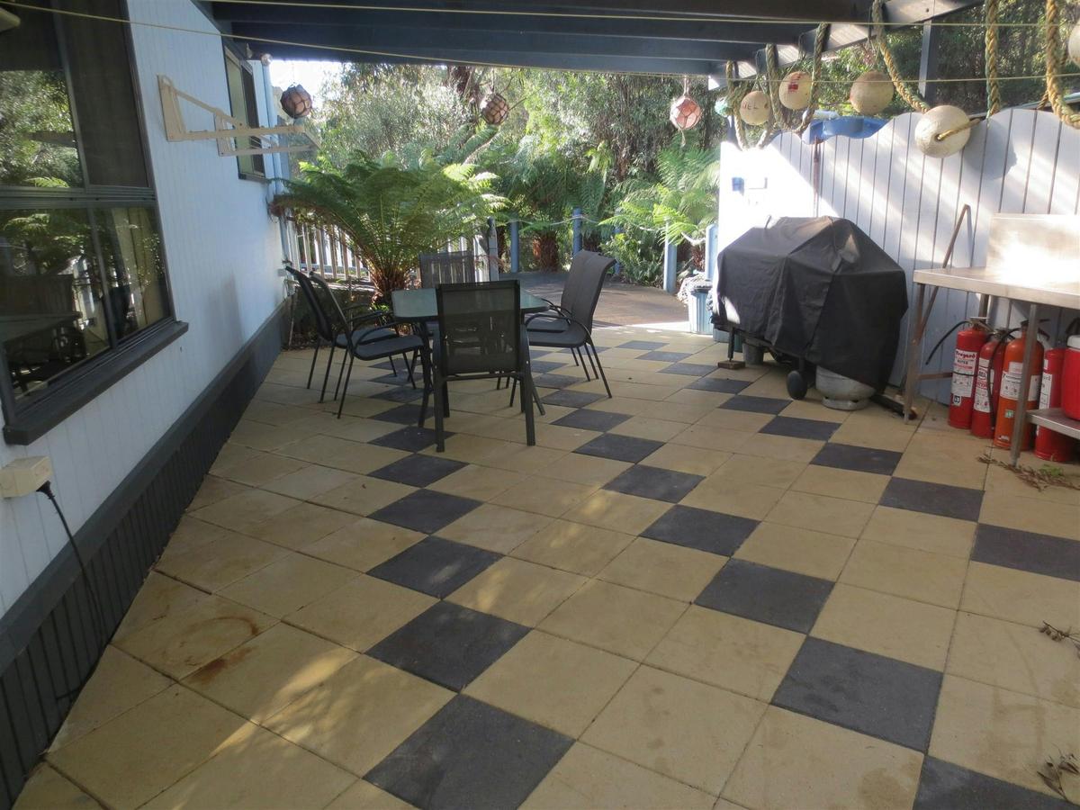under cover bbq area at rear of house