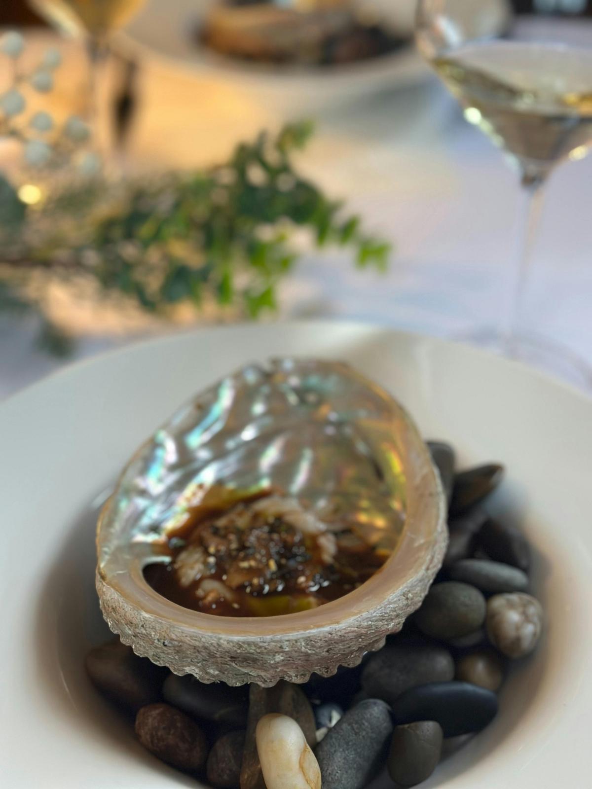 Delicous abalone served in an abalone shell with