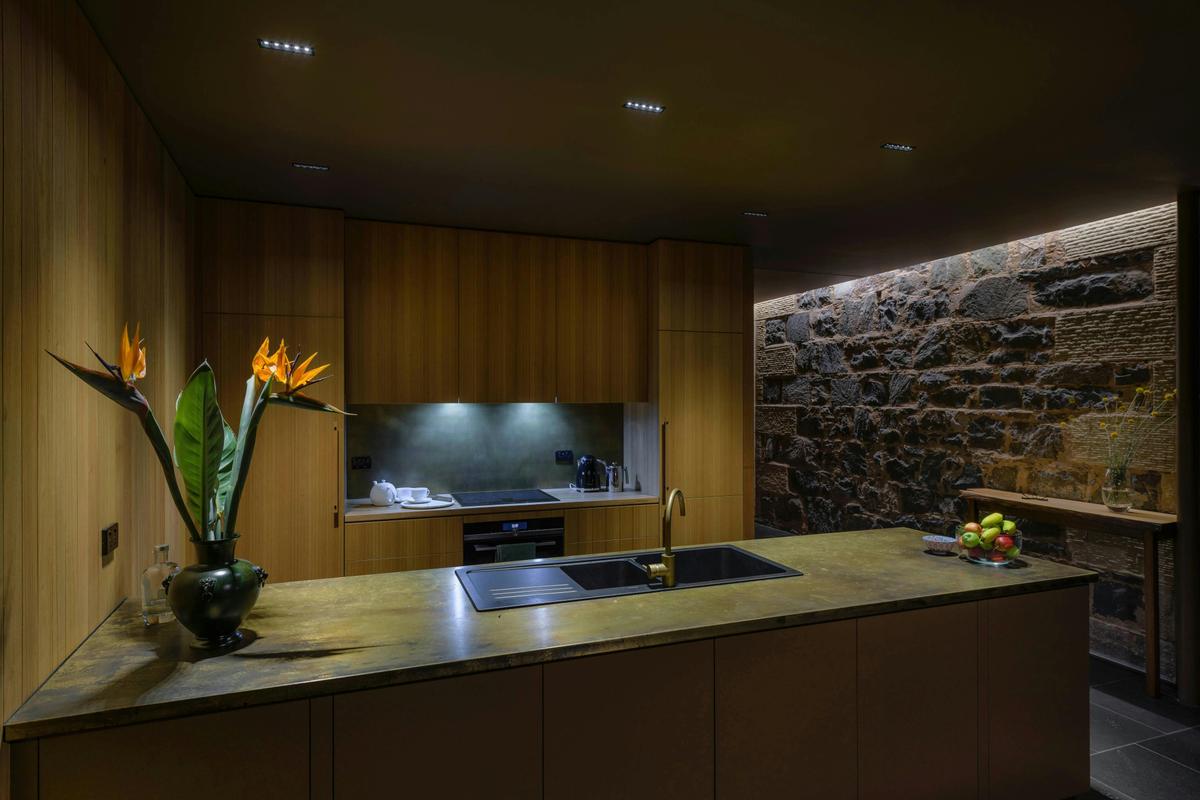 Kitchen with brass bench & splashback