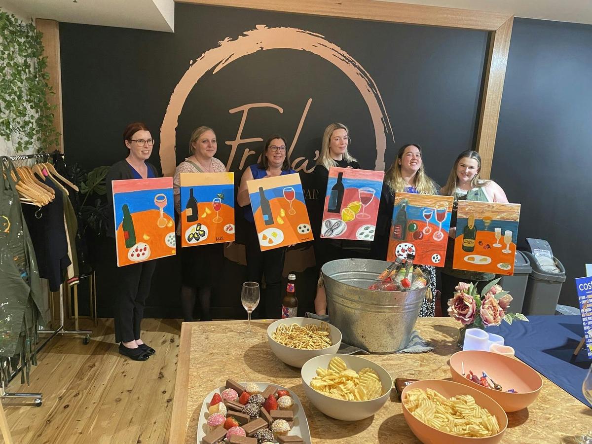 Happy customers, showing off their artwork .