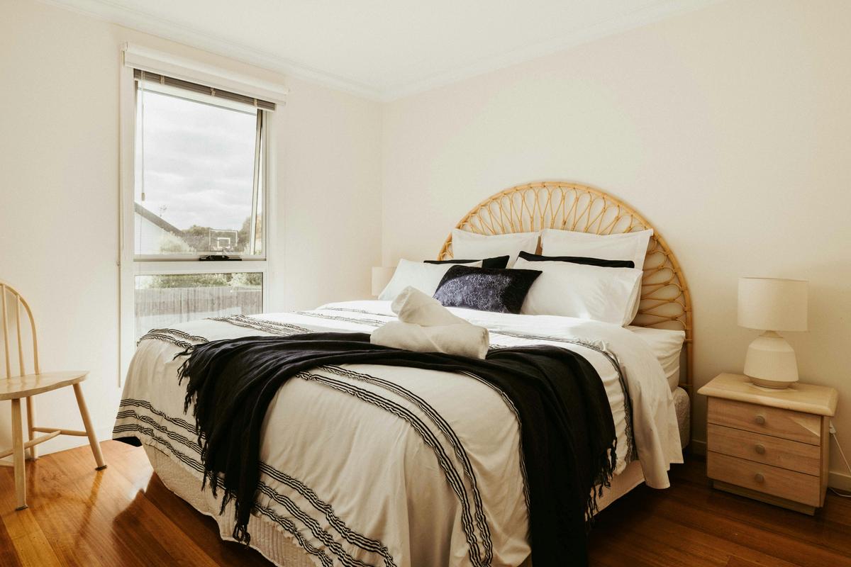 The third bedroom is spacious and private, it boasts serene backyard views for a peaceful retreat.