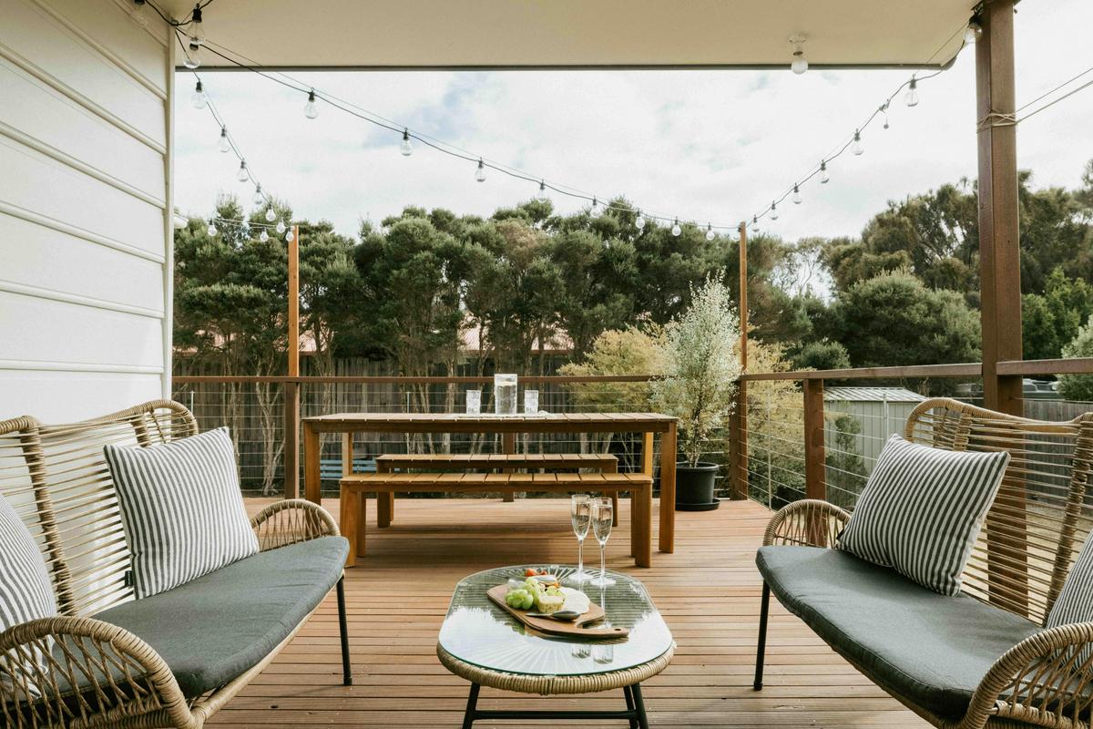 The balcony area offers plenty of seating and two separate doors leading to the outside.