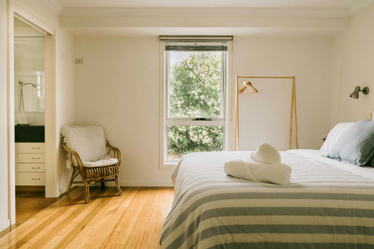 The master bedroom has a king bed with luxurious linen and an ensuite.