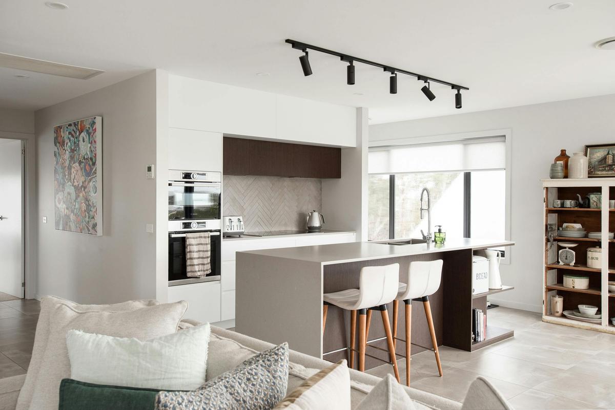 The kitchen is well equipped with an induction cooktop, oven, microwave and dishwasher.