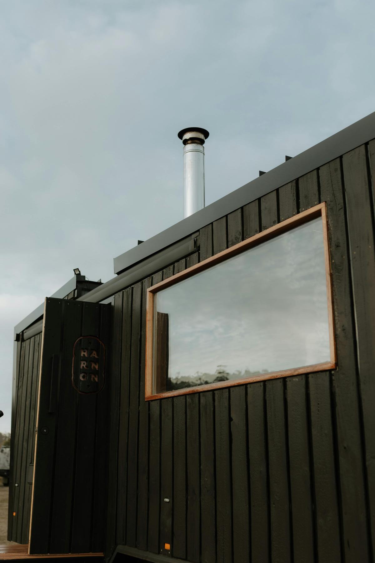Handcrafted mobile sauna with panoramic viewing window.