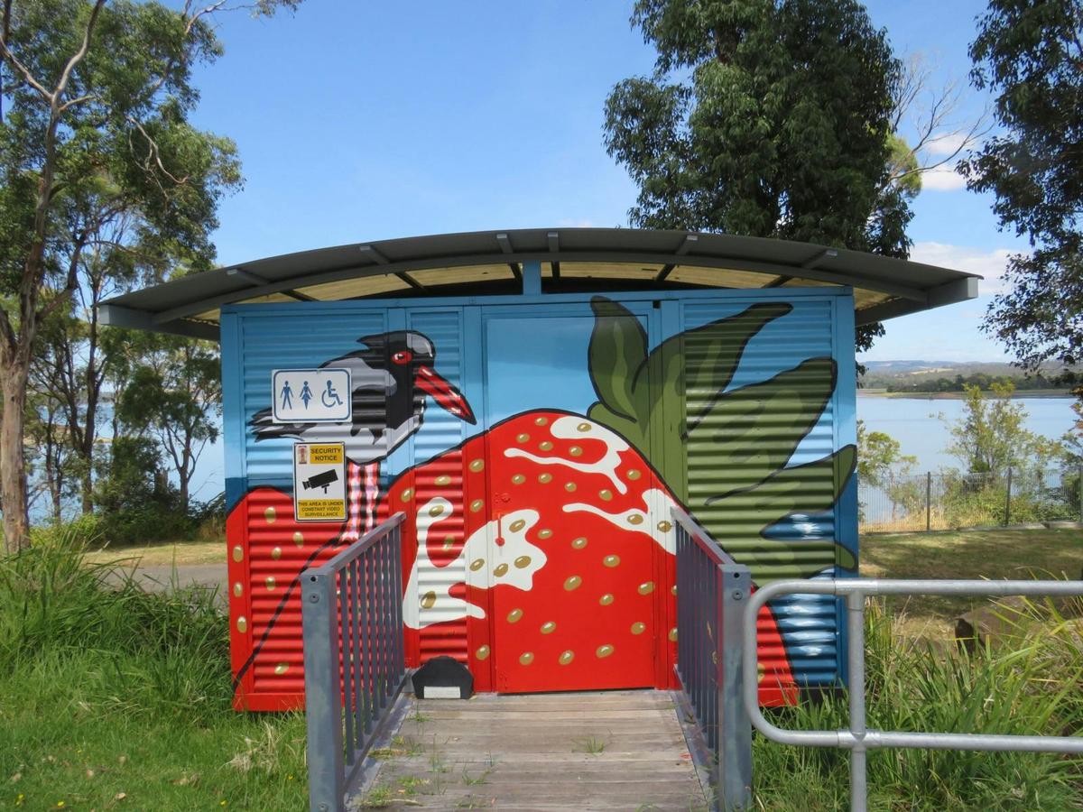 A Oyster Catcher perches on a giant strawberry