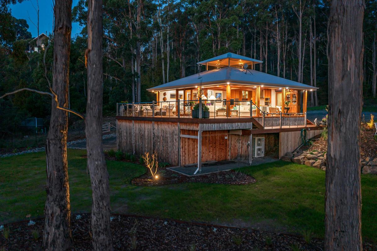 A wide shot of the Huon River Hideaway facing away from the river at dusk