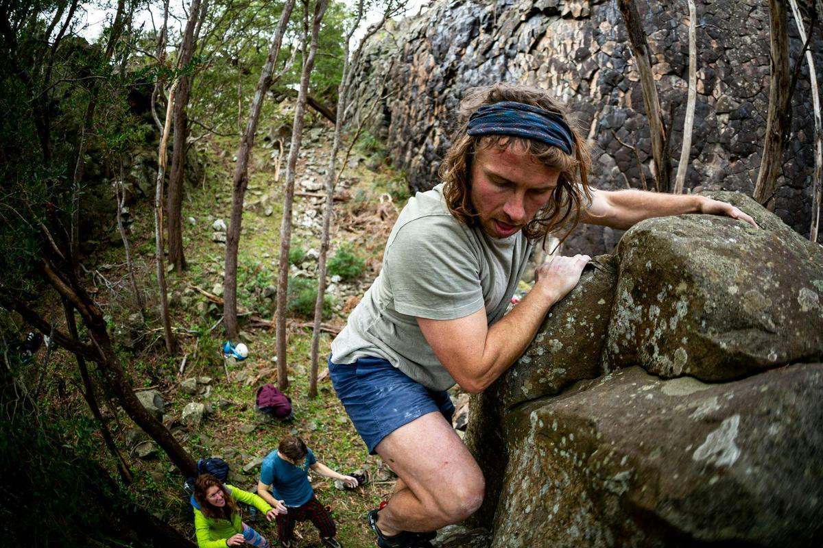 A climber bouldering at Hillwood Rock Climbing facilities