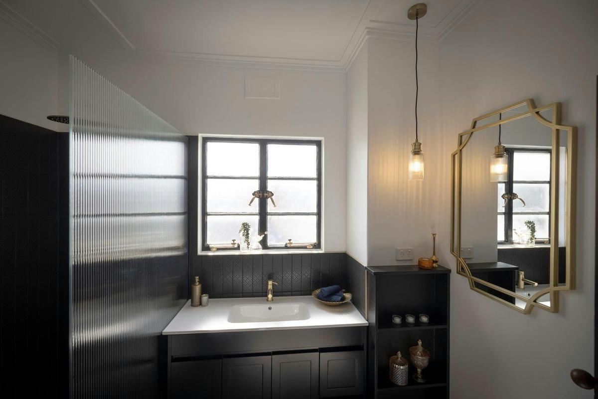 A rainfall shower and classic tilework that celebrates the timeless elegance of the era.