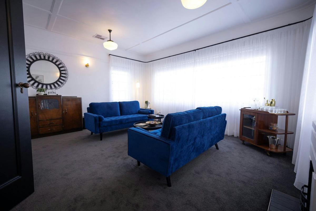 A spacious living area filled with natural light, and décor that echo the opulence of the 1930s.