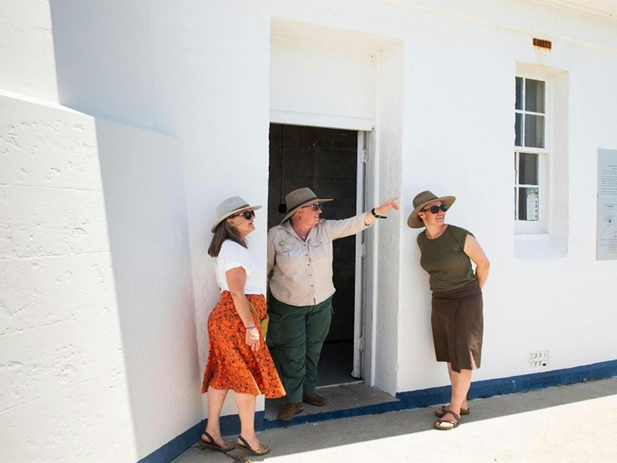 Visitors being met by an NPWS guide at the door of Smoky Cape Lighthouse, Hat Head National Park.
