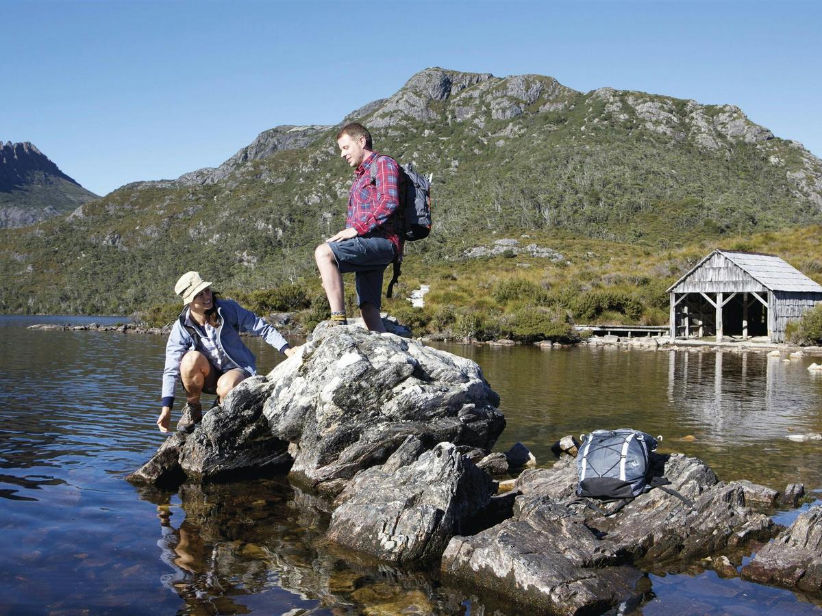 A peaceful moment at Dove Lake, featuring the famous boatshed and surrounding wilderness.