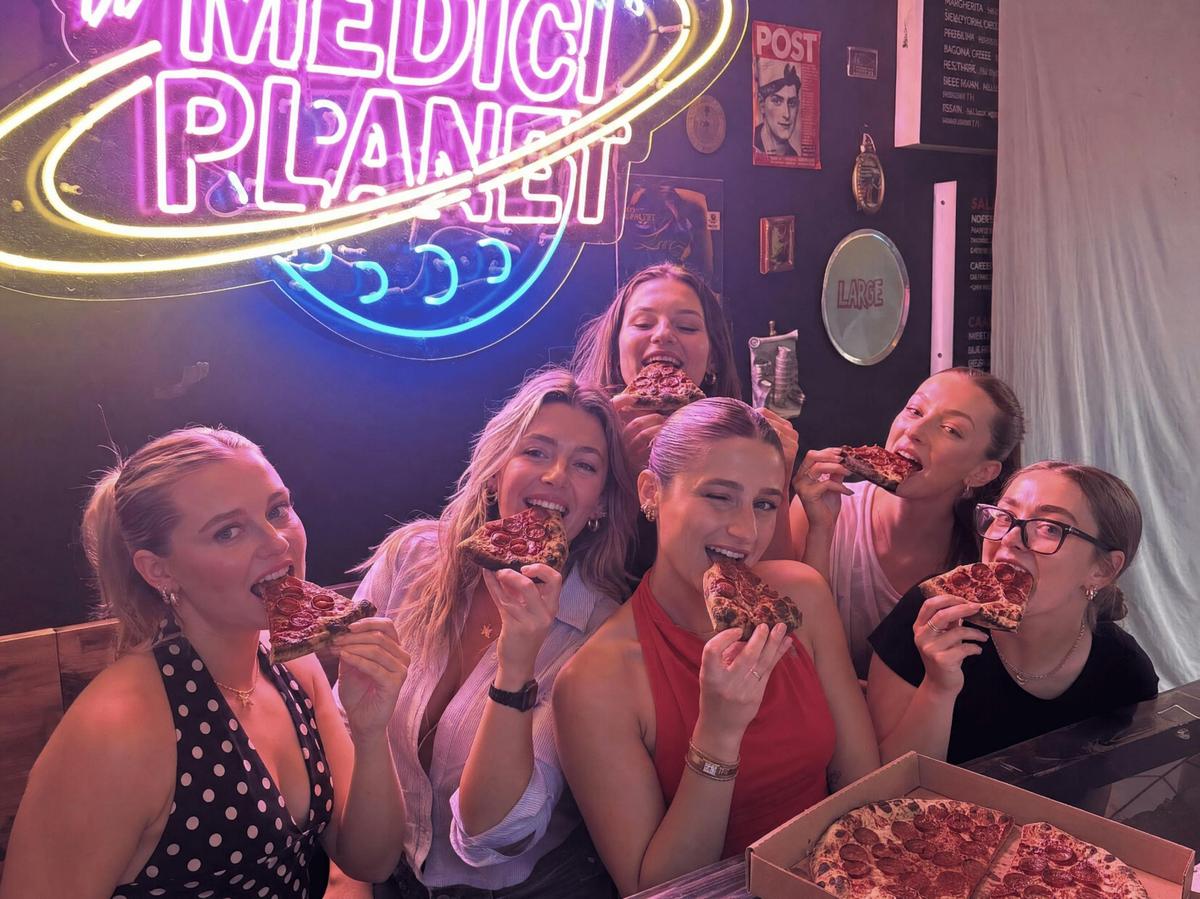 Sharing pizza inside Medici Pizzeria