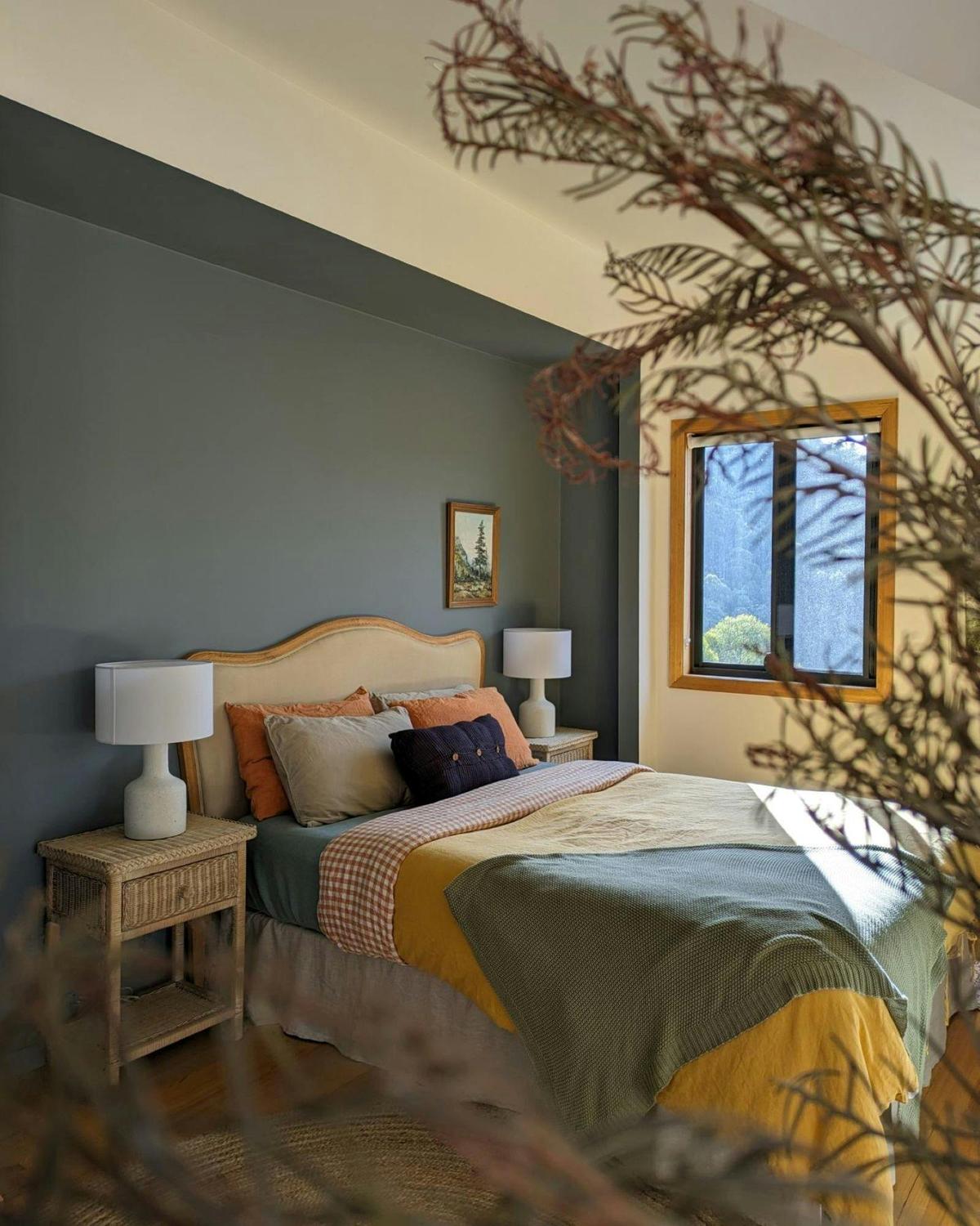 Sleep on luxury linens in the master bedroom with window views over the orchards