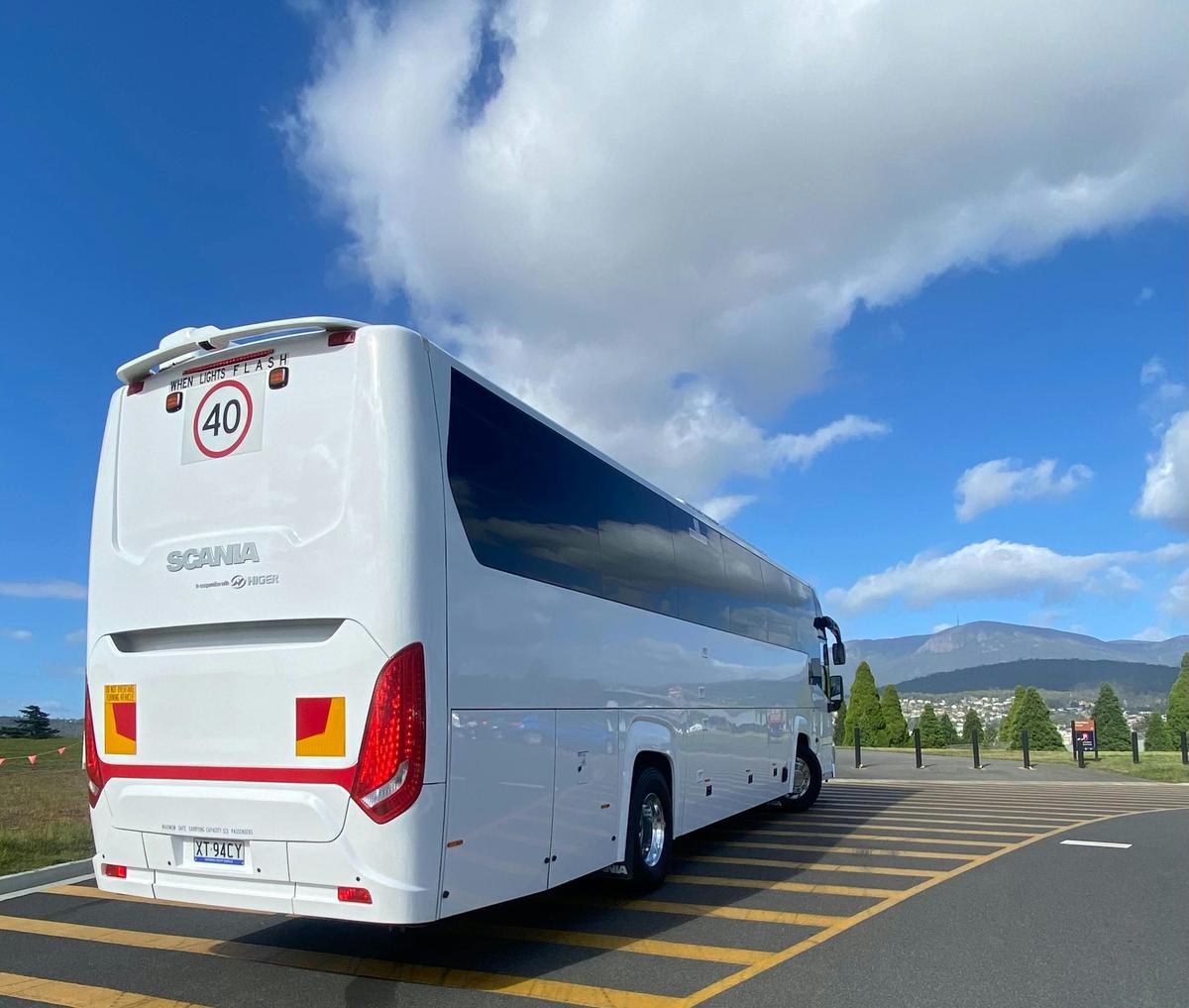 Luxury coach parked in scenic area, facing the view