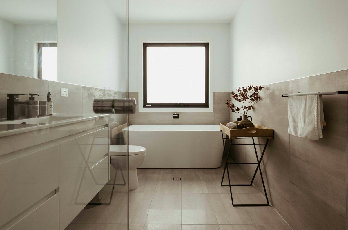 The master ensuite is sleek and modern, complete with a relaxing bathtub and a spacious shower.