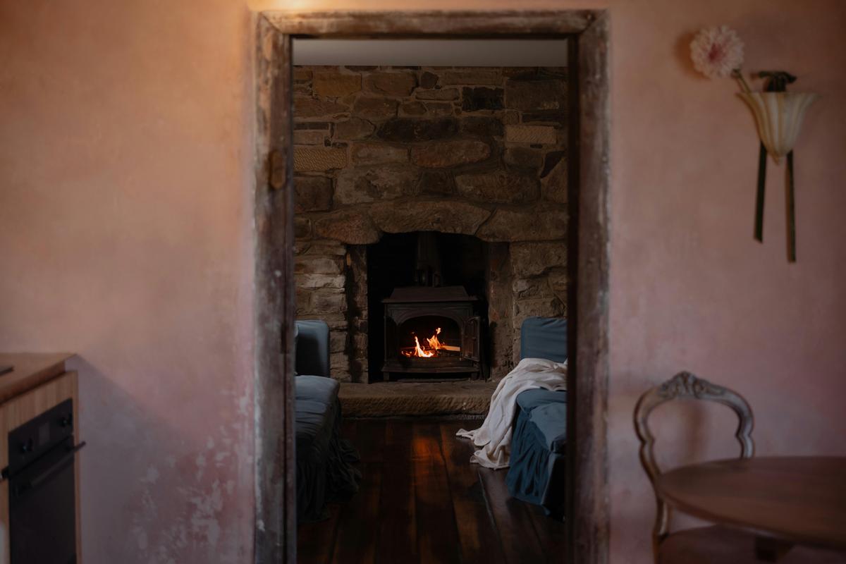 A cozy lounge surrounds wood fire
