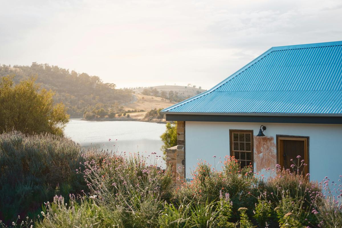 The cottage is surrounded by beauty - pollinating gardens to the front and the river behind