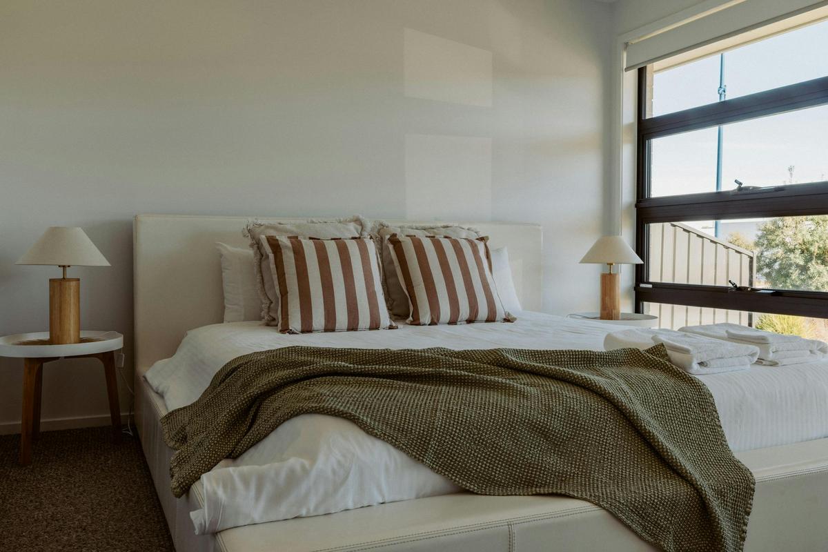 The Master bedroom has a super kind bed, walk-in robe and ensuite