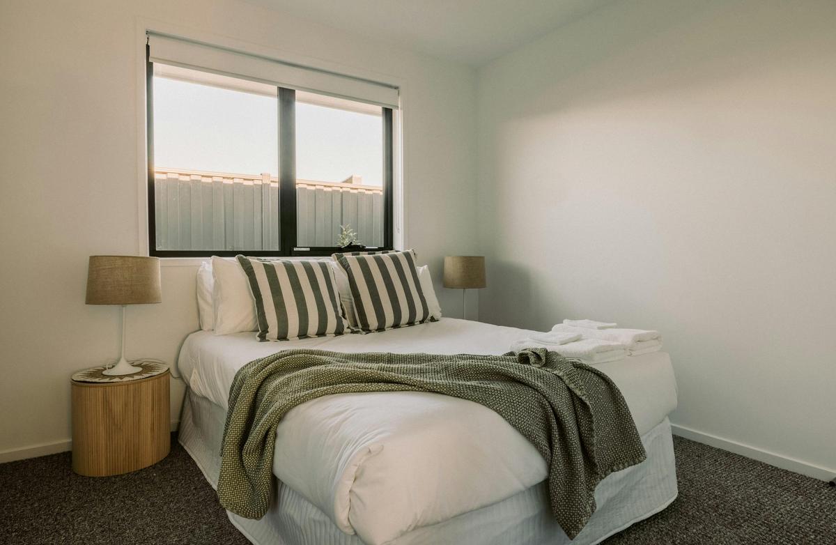 The second bedroom, with a comfy double bed and wardrobe, is located next to the bathroom.
