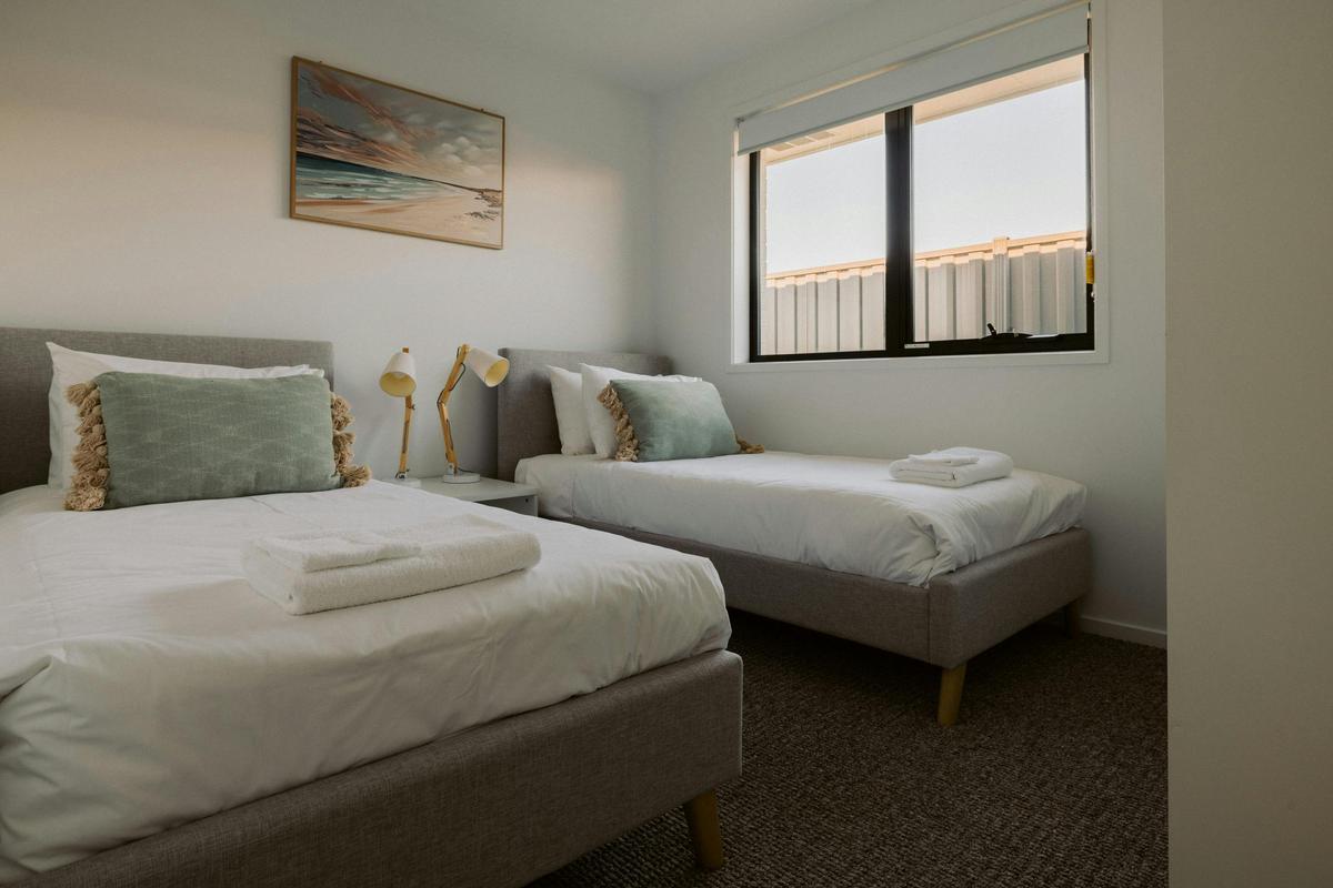 The third bedroom has 2 single beds and a sliding wardrobe.