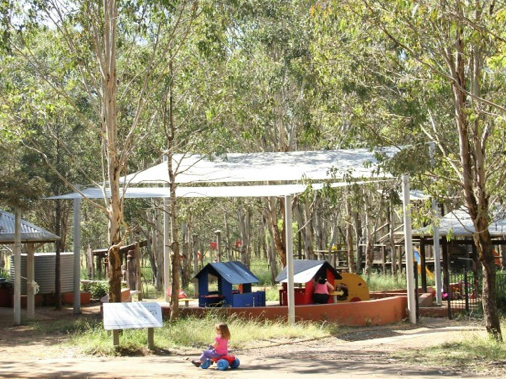Family picnic and adventure playground area overlooking a toddlers' play space in Rouse Hill