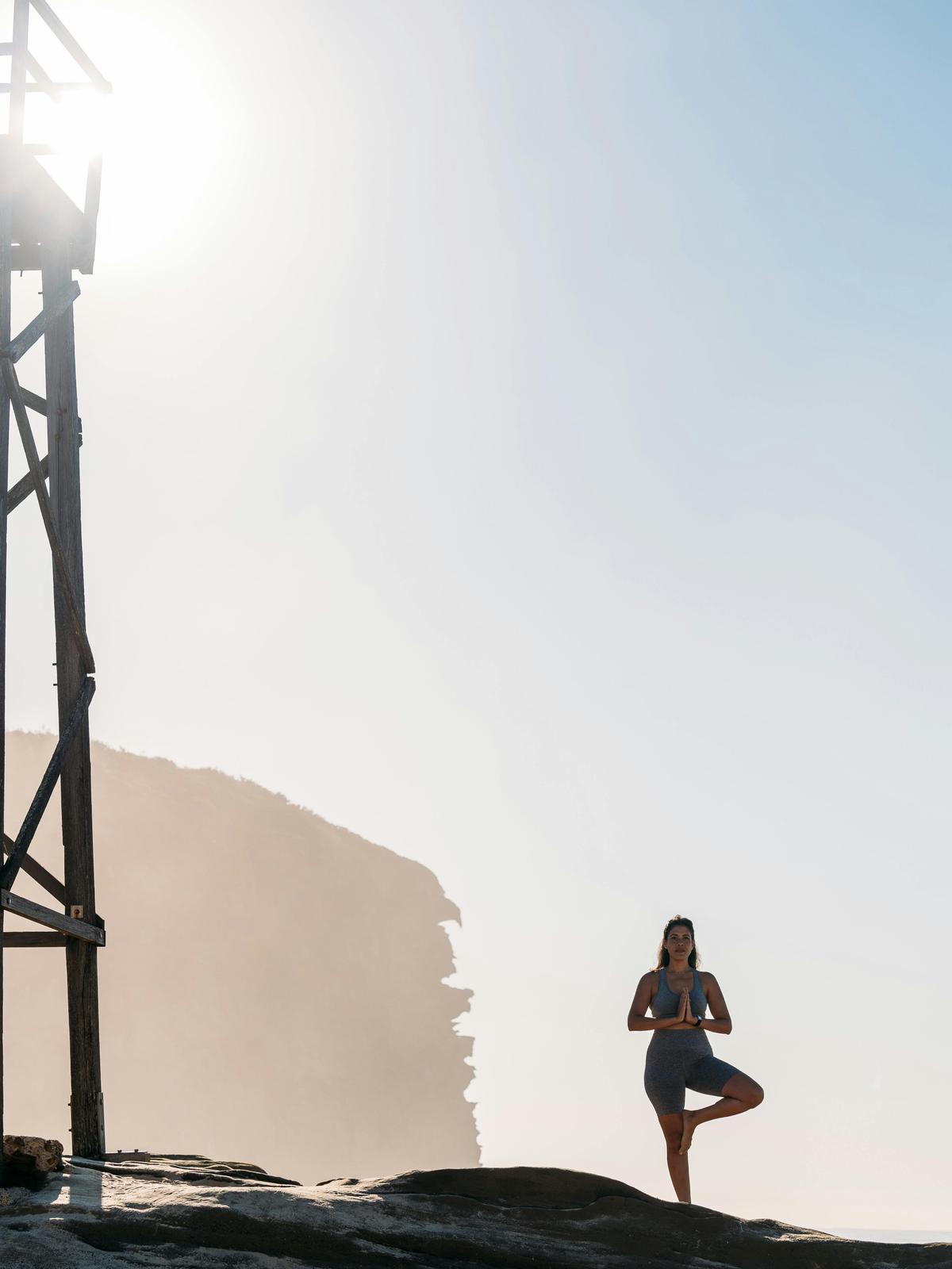 Lady enjoying sunrise yoga
