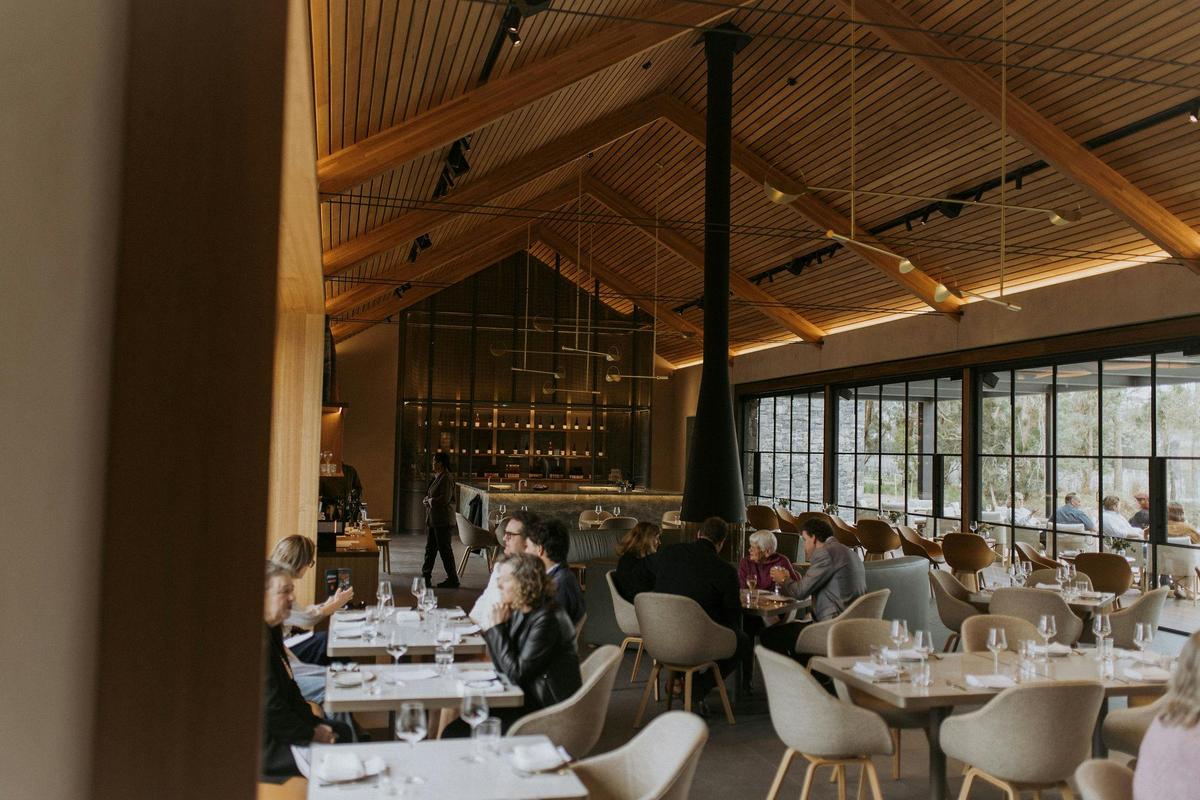 Inside the winery and restaurant with the central fireplace and views over the vineyard