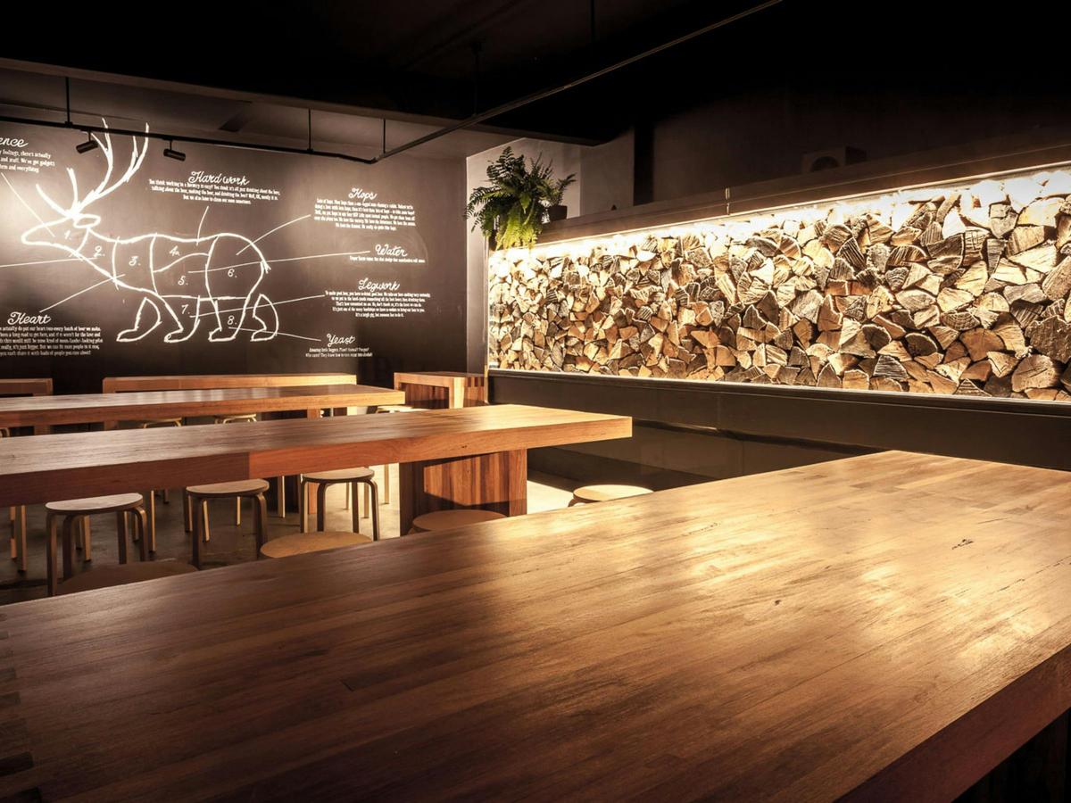Book at table at our front bar and enjoy our beer next to some meticulously stacked firewood!