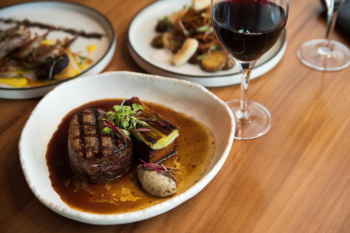 Steak dish and a glass of red wine