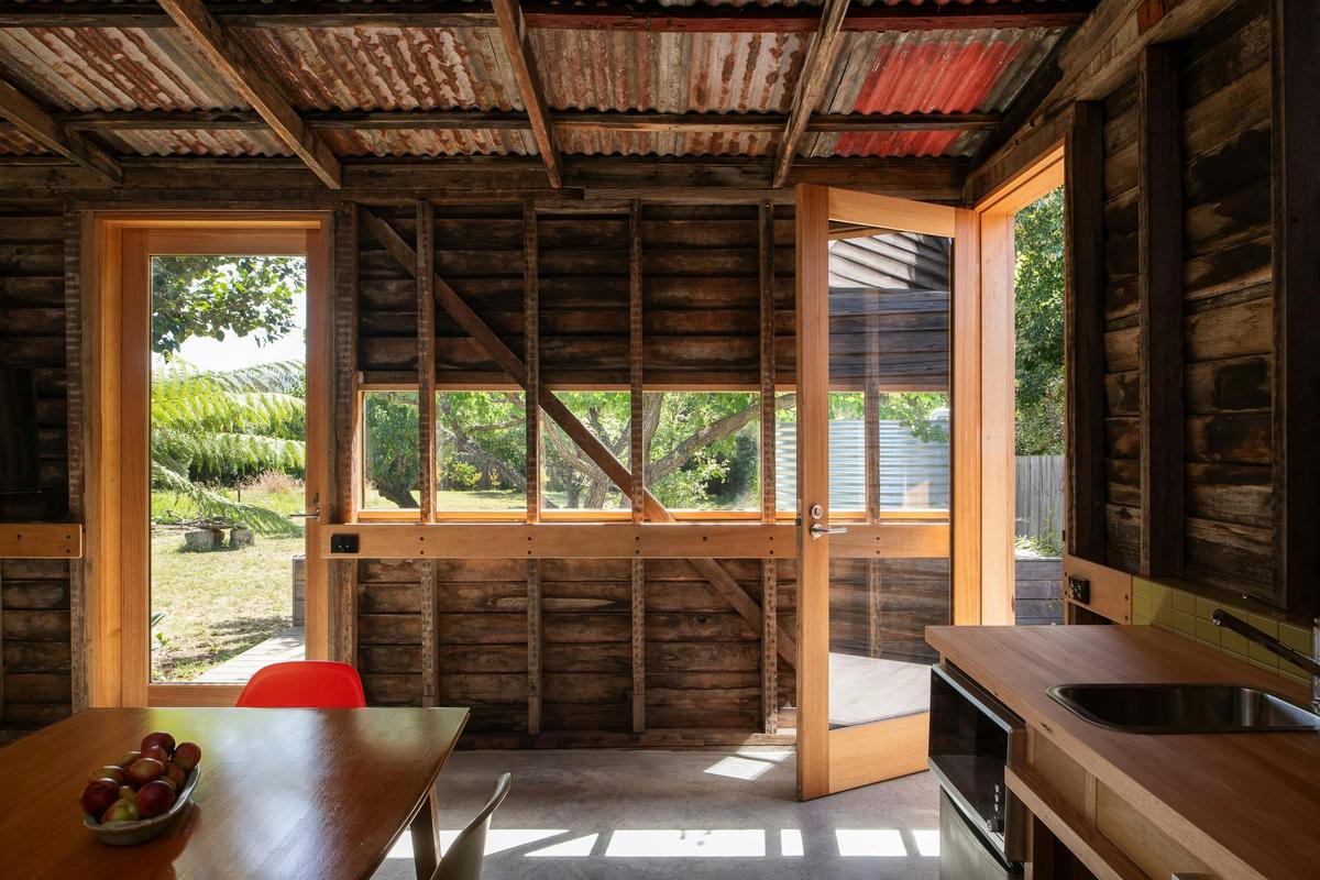 Dining area with accessible kitchenette looking out to deck and orchard garden