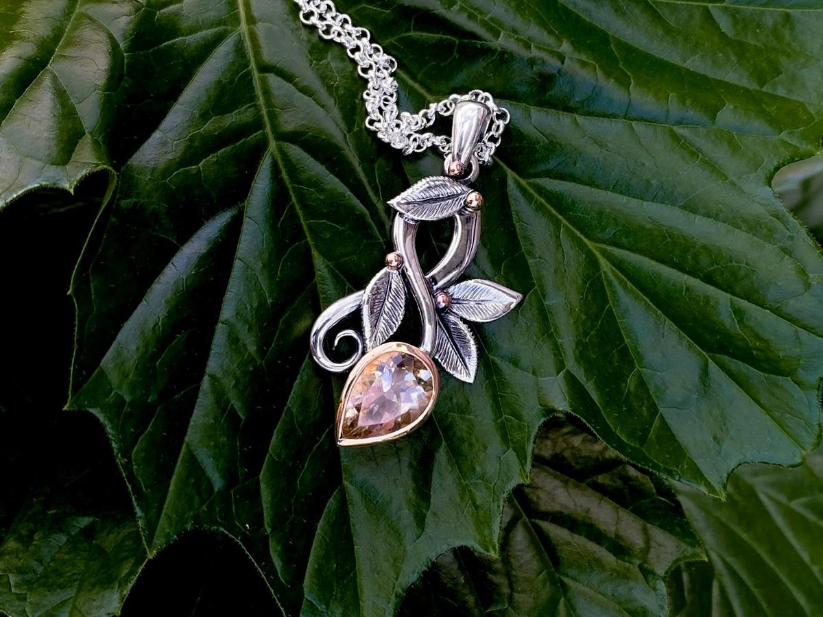 New flourish necklace with pink zircon set in silver floral embellishments by Emily Duggan