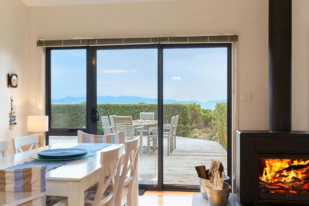 Dining area with sea and mountain views