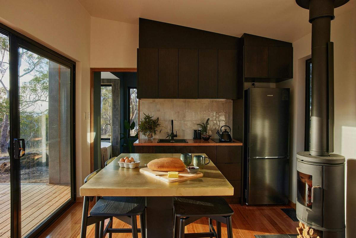 The Croft's kitchen features a handcrafted brass island bench