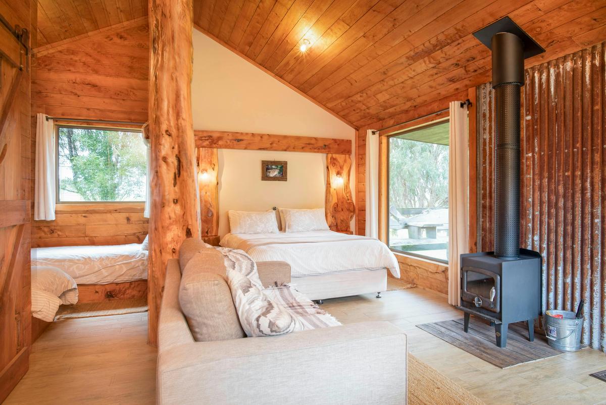 Country Hut - view into bedroom with 2 single beds and Queen Bed