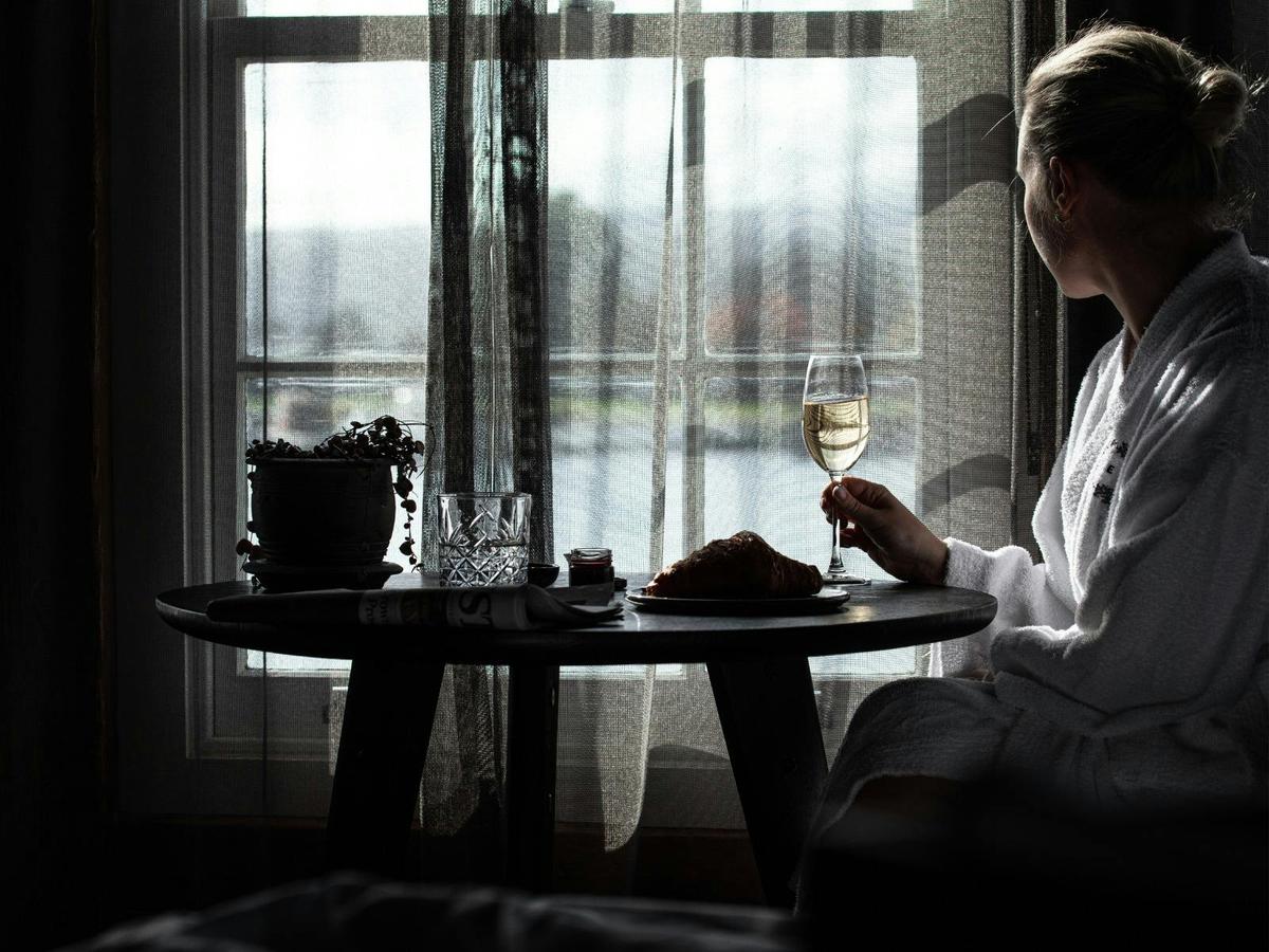 Enjoying a glass of bubbles by the window