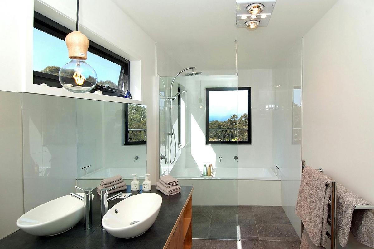 Spacious luxury bathroom with rainshower and bathtub