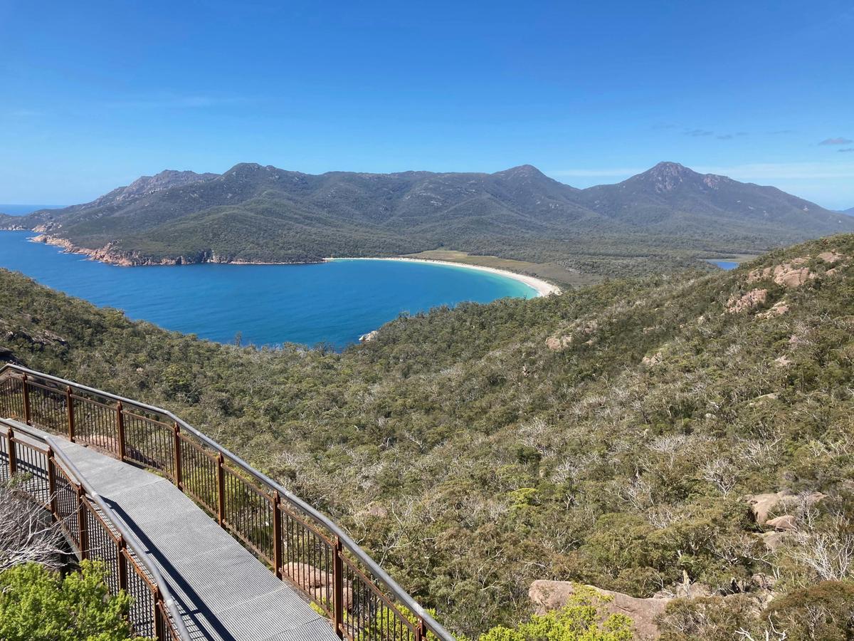 Wineglass Bay in Freycinet National Park with pink granite mountains and pristine white beach