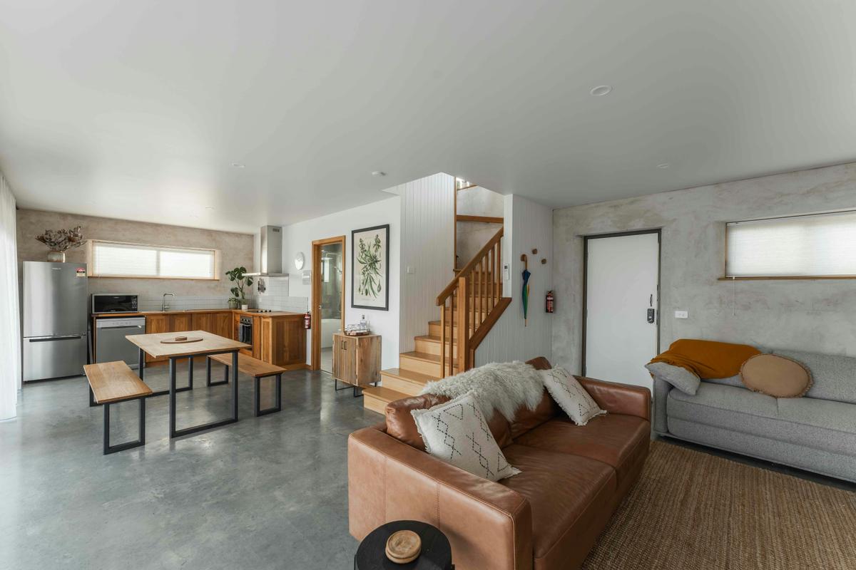 A comfortable and relaxed living and dining area on the ground floor with doors opening to patio.