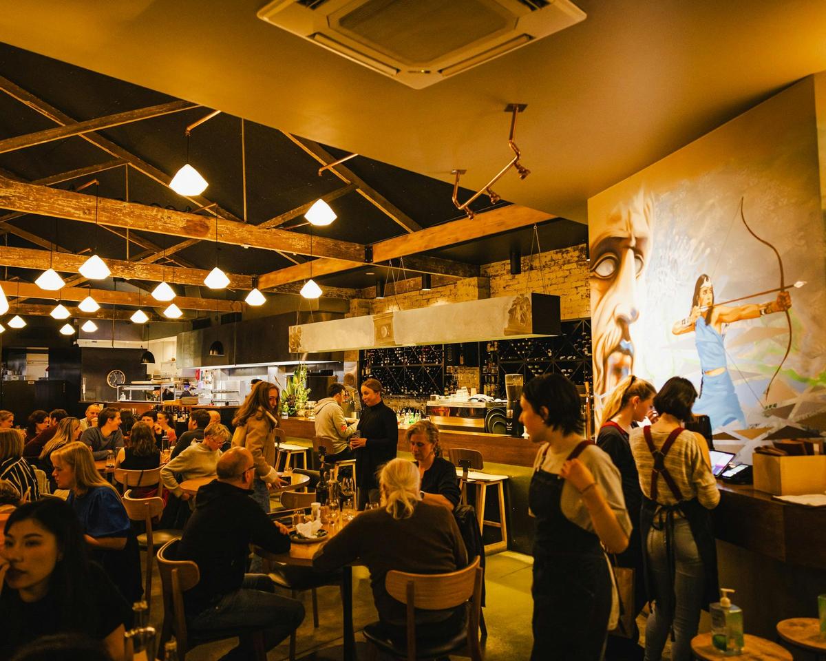 A lively evening inside Urban Greek, where guests enjoy shared dining and warm Greek hospitality.