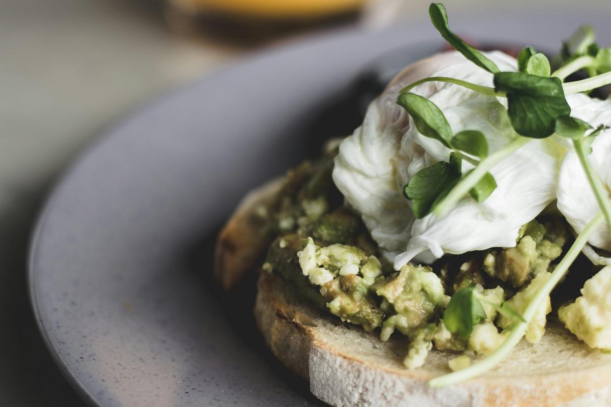 Smashed avocado and poached eggs on sourdough.