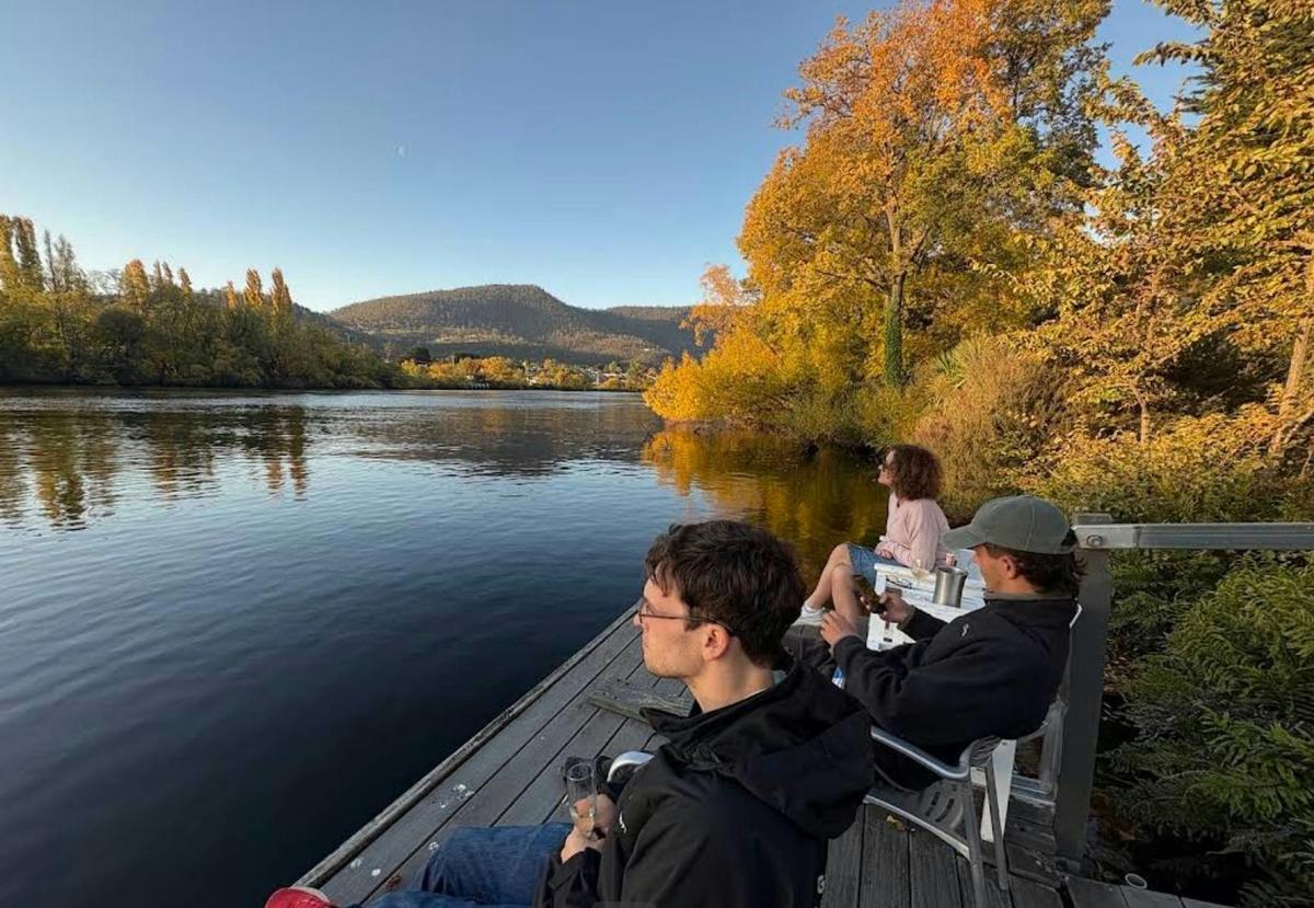 Guests relaxing on The Woodbridge's pontoon on the Derwent River, Tasmania